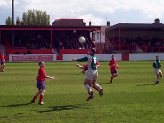 Russell Edwards going for the ball as Mark Janney watches